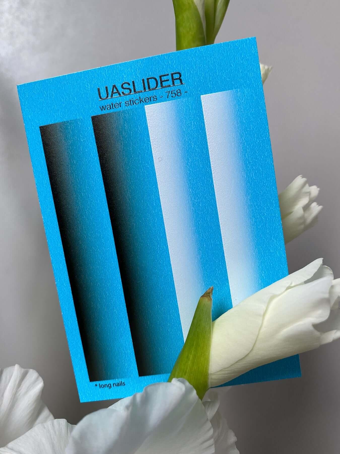 Nail Water Decal 758 on a blue background with white floral accents, showcasing vibrant water slide nail art options.