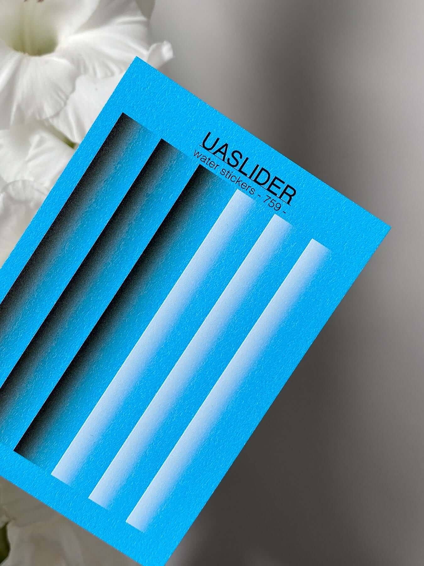 Nail Water Decal 759 featuring vibrant water slide designs on a blue background.