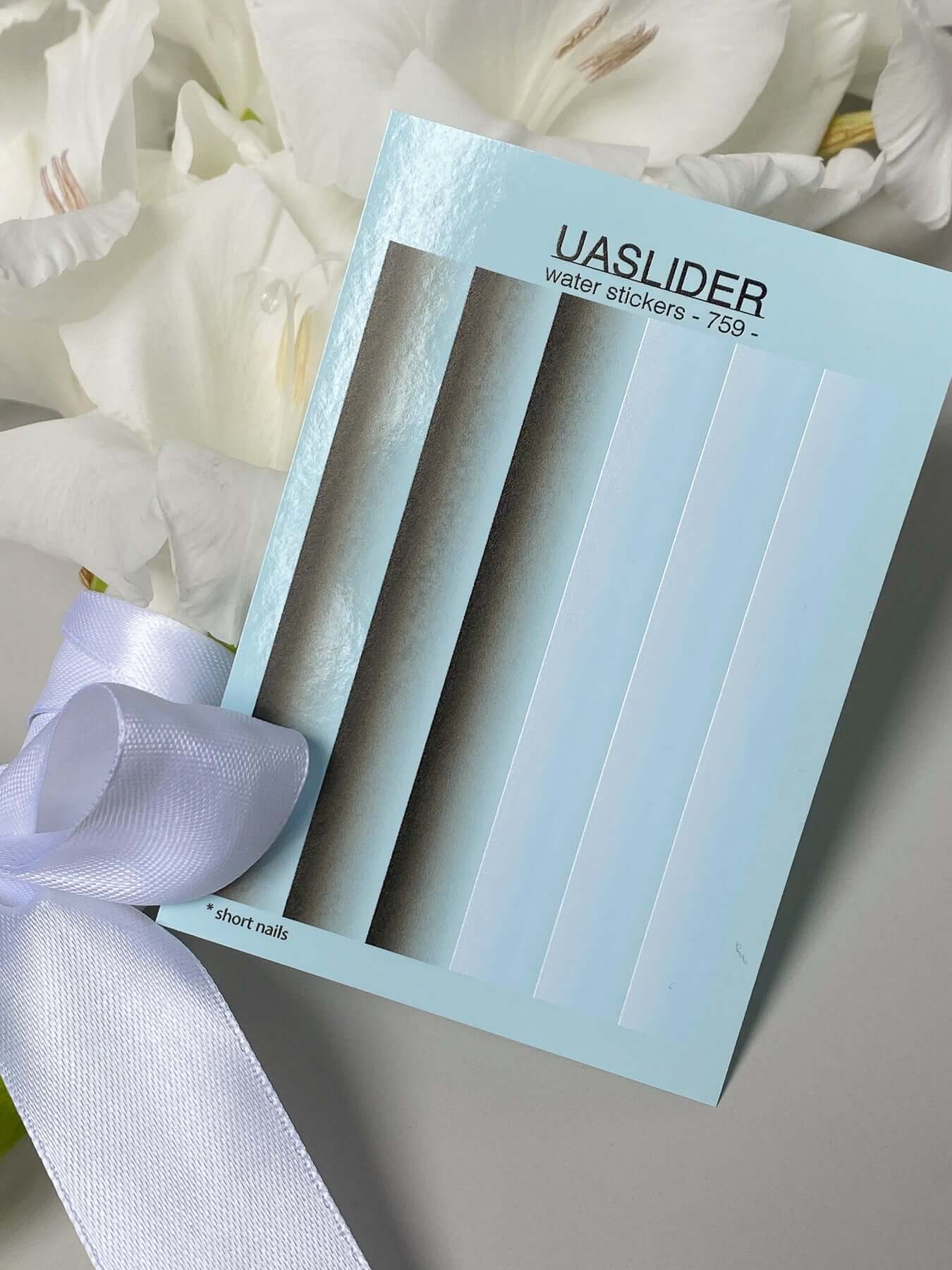 Nail Water Decal 759 showcased with short nail water stickers on a blue card against a floral background.